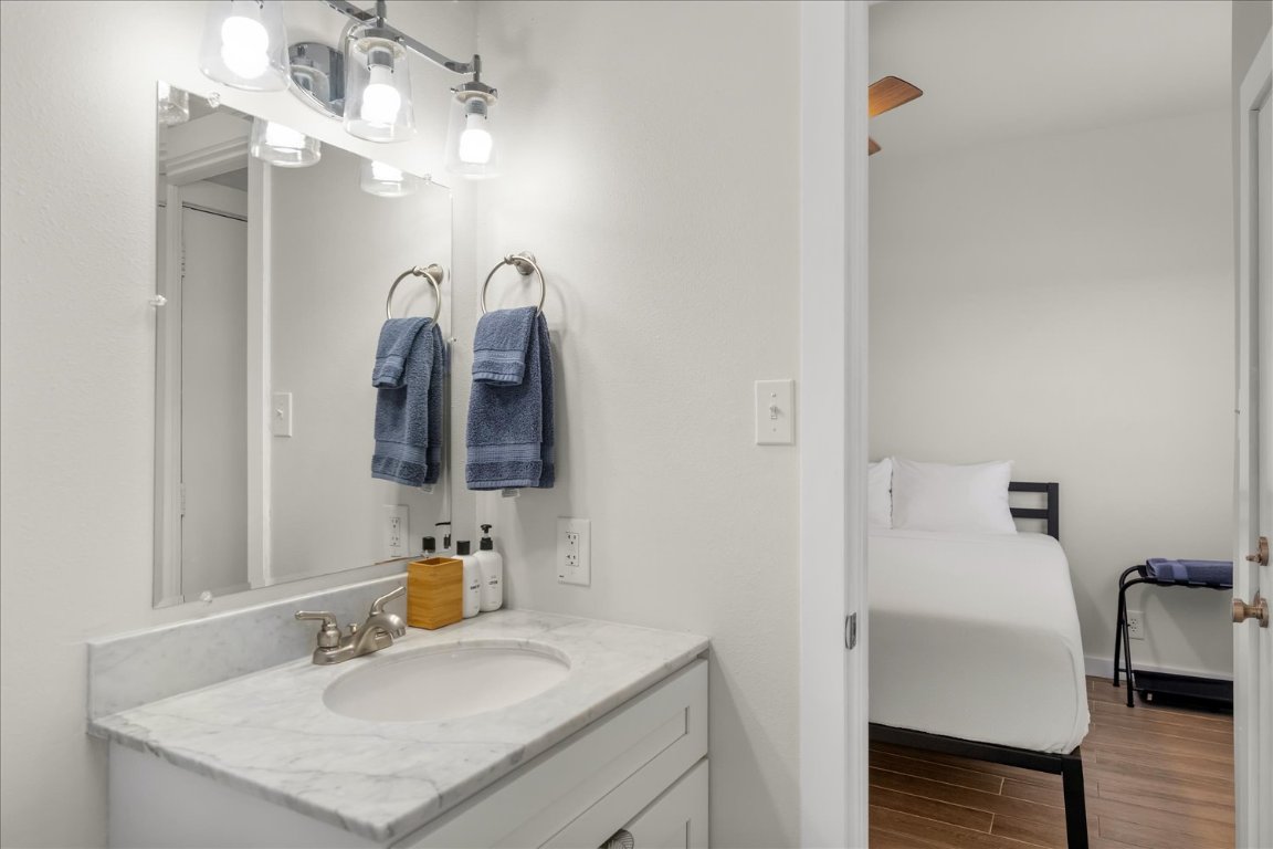 3316 Guadalupe Street, Unit 310 Austin, TX 78705 - Photo 25 of 38 a bathroom with a sink vanity and a mirror