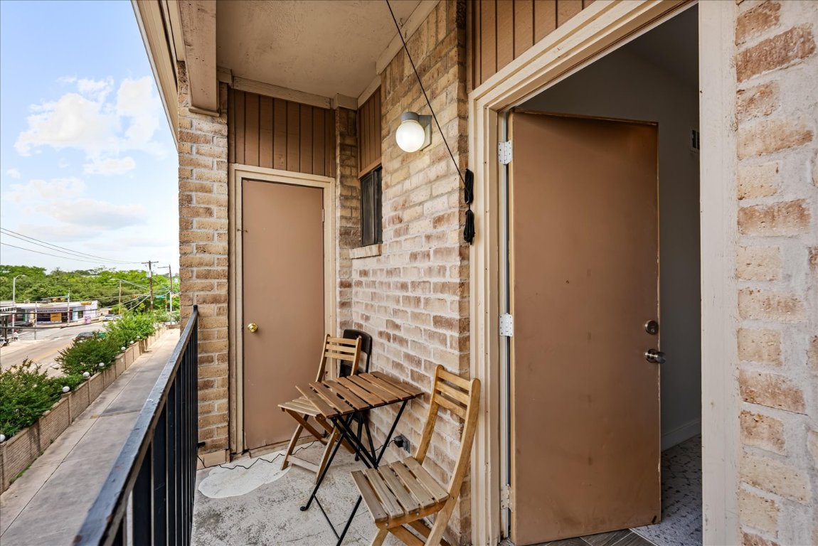 3316 Guadalupe Street, Unit 310 Austin, TX 78705 - Photo 26 of 38 a view of a balcony with chairs and a table
