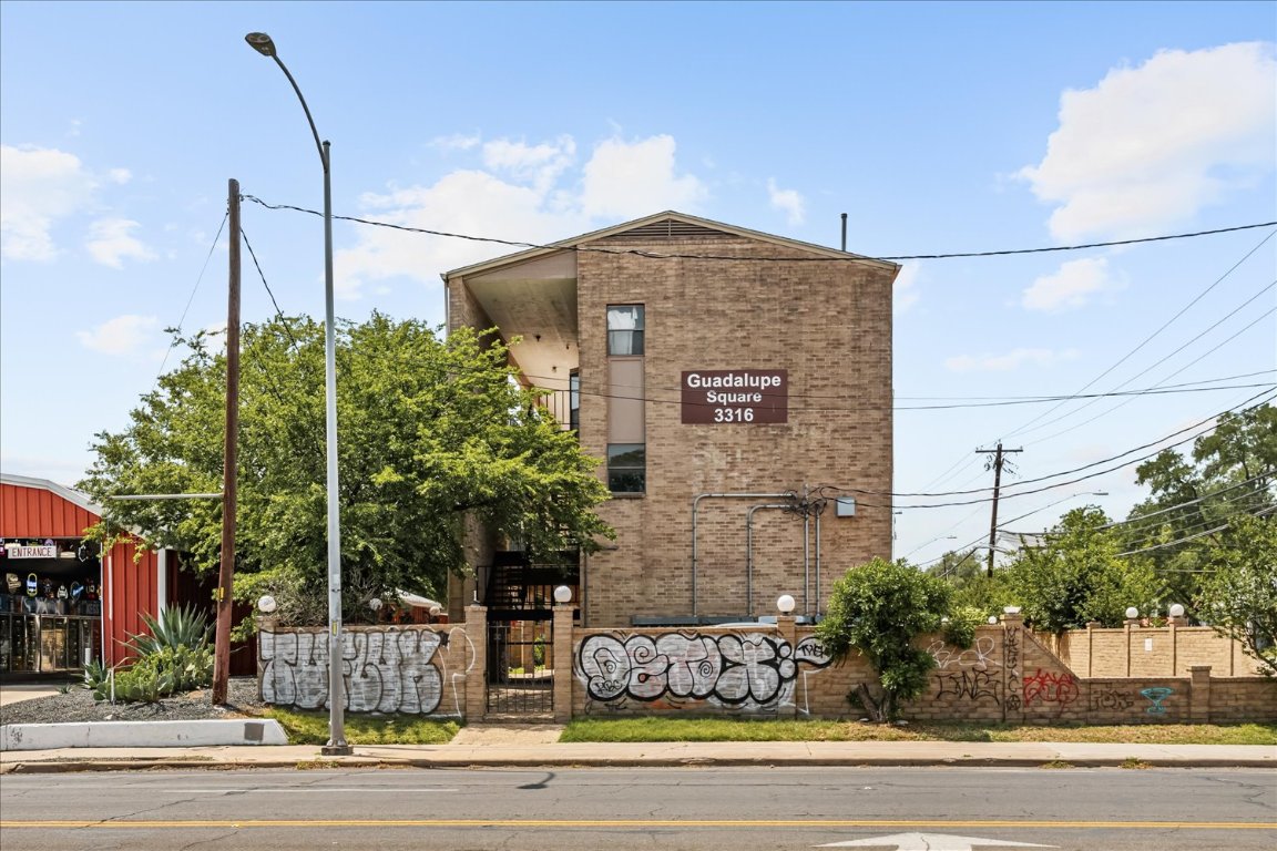 3316 Guadalupe Street, Unit 310 Austin, TX 78705 - Photo 35 of 38 a front view of a house with a yard