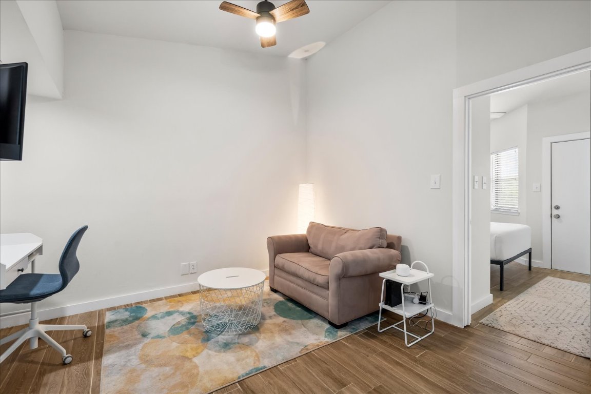 3316 Guadalupe Street, Unit 310 Austin, TX 78705 - Photo 5 of 38 a living room with furniture and a wooden floor