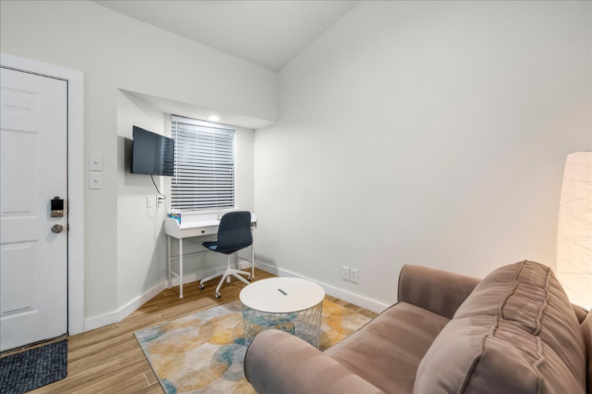 3316 Guadalupe Street, Unit 310 Austin, TX 78705 - Photo 6 of 38 a living room with furniture and a flat screen tv