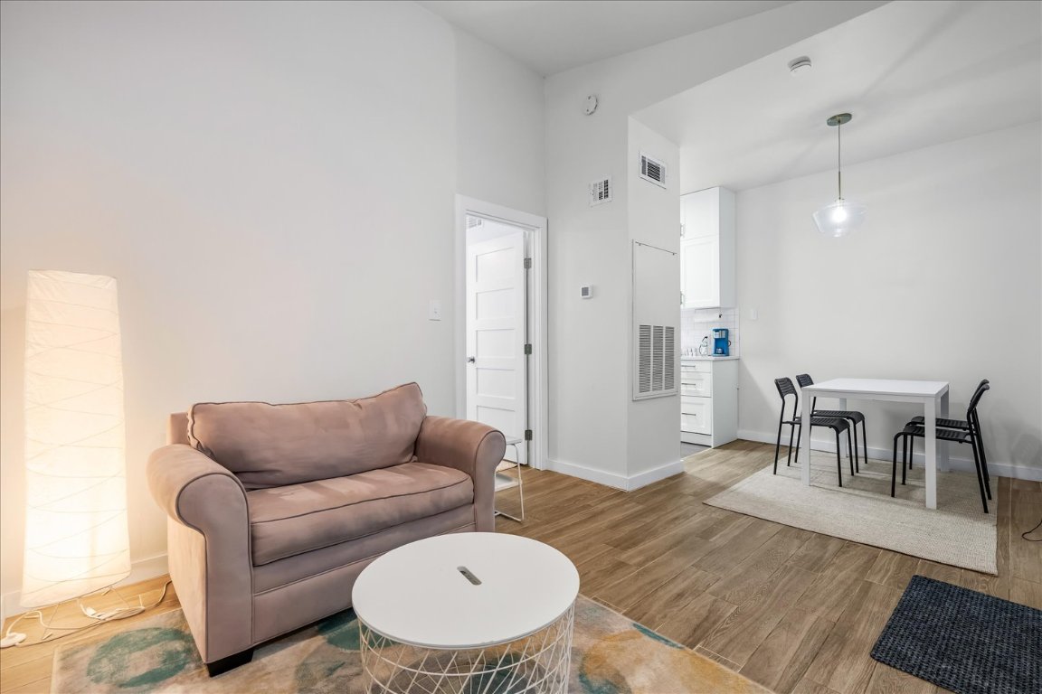 3316 Guadalupe Street, Unit 310 Austin, TX 78705 - Photo 7 of 38 a living room with furniture and a dining table