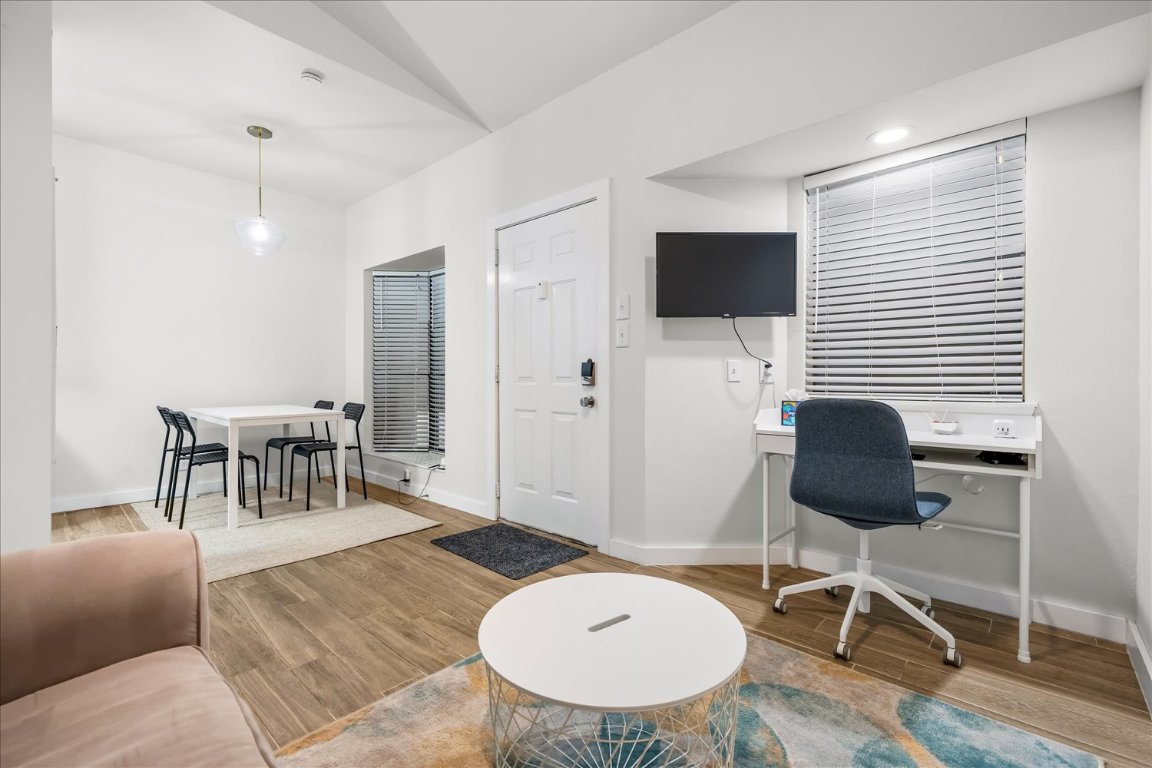3316 Guadalupe Street, Unit 310 Austin, TX 78705 - Photo 8 of 38 a living room with furniture and a wooden floor