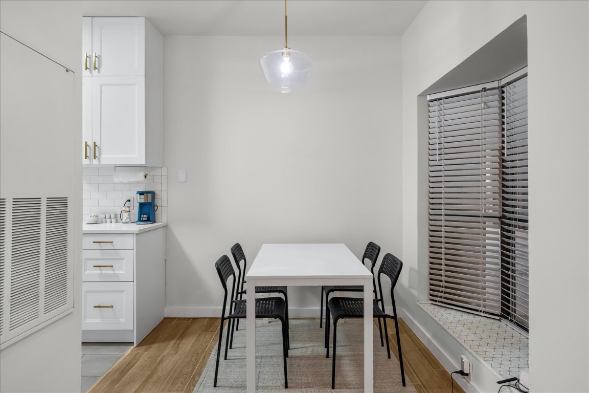 3316 Guadalupe Street, Unit 310 Austin, TX 78705 - Photo 10 of 38 a view of a dining room with furniture and wooden floor