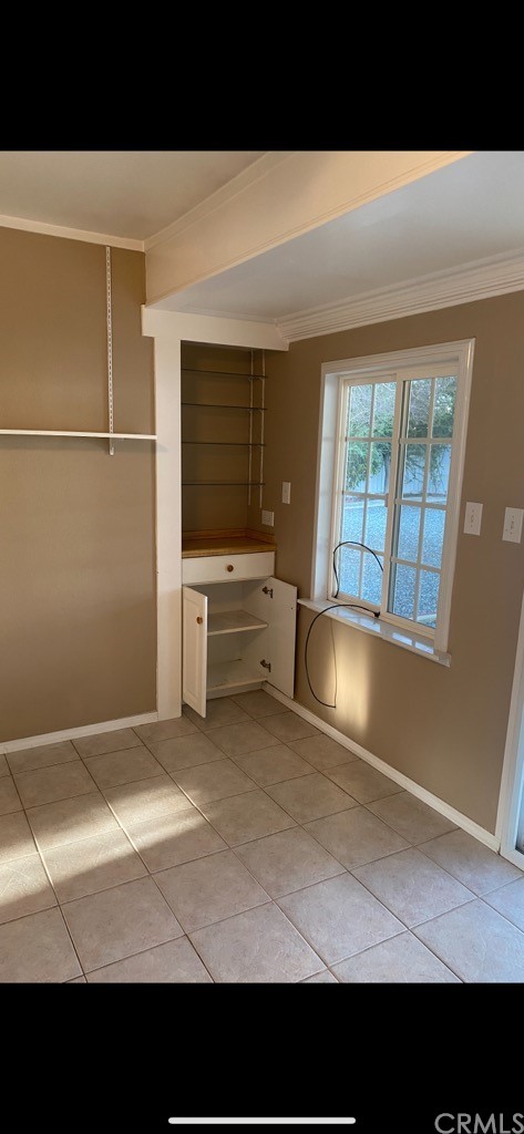 27310 Capilano Drive Menifee, CA 92586 - Photo 8 of 10 a view of an empty room with a fireplace and a window