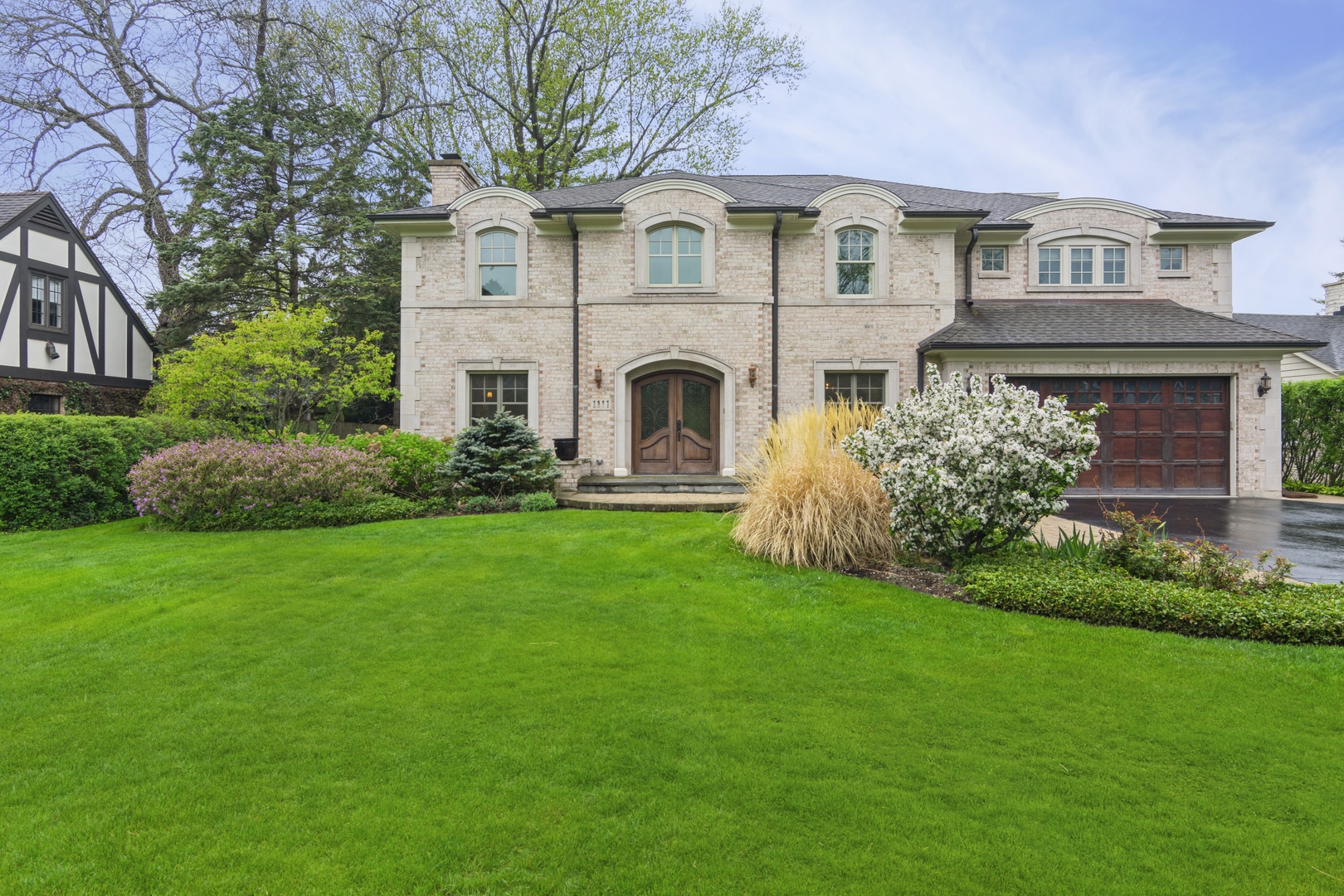 a front view of a house with a garden