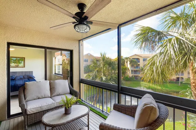 a living room with furniture and a floor to ceiling window