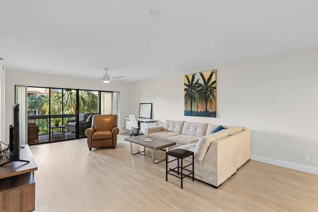 a living room with furniture and a large window with outer view