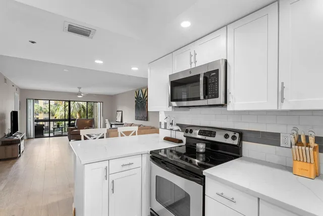 a kitchen with a sink stove and microwave