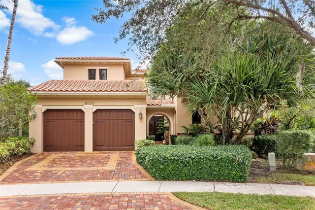 a kitchen with granite countertop a table chairs microwave and cabinets