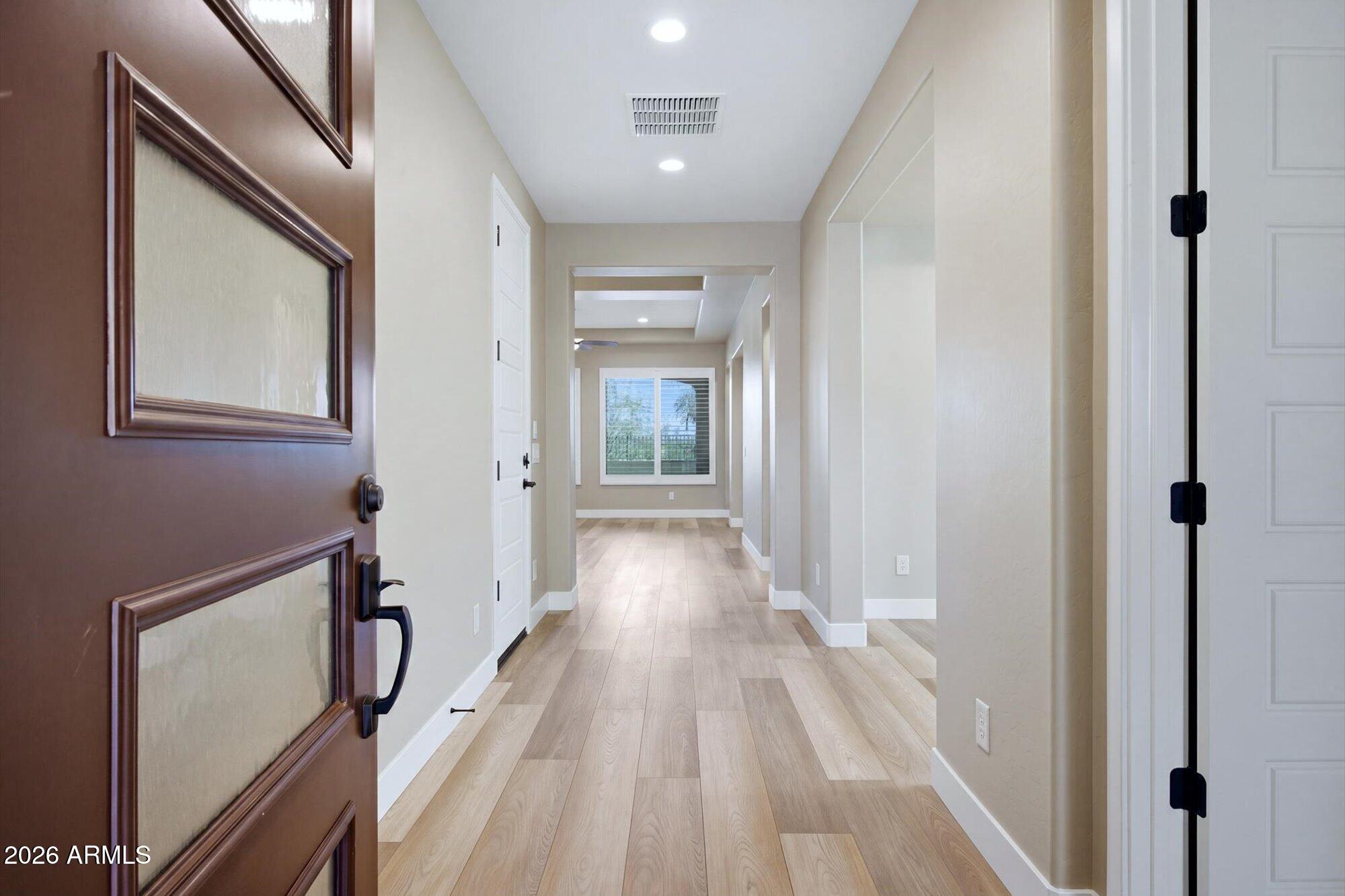 16849 West Merrell Street Goodyear, AZ 85395 - Photo 2 of 35 a view of a hallway with wooden floor and staircase