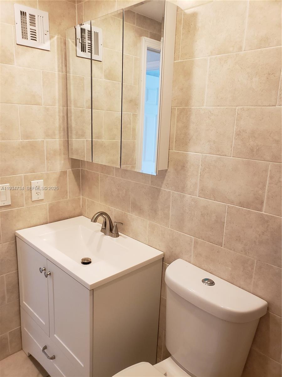 200 South Birch Road, Unit 203 Fort Lauderdale, FL 33316 - Photo 10 of 10 a bathroom with a sink mirror and toilet