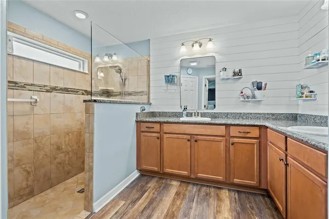 a view of a dining room with furniture a chandelier and wooden floor