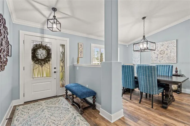 a dining room with furniture window and wooden floor