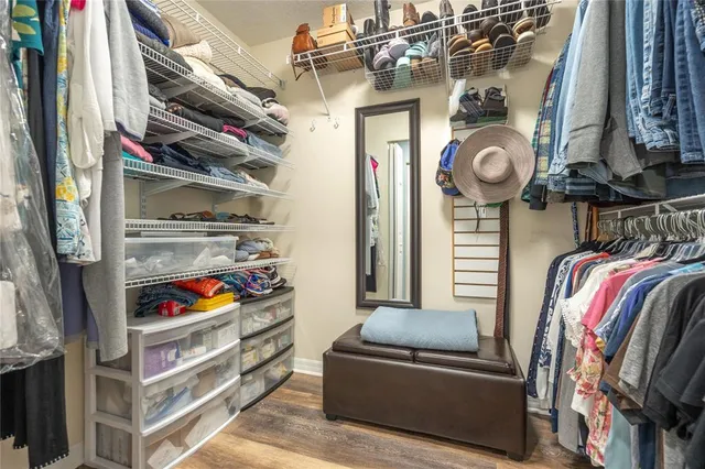 a bedroom with a large bed and a flat screen tv