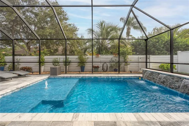 a view of a patio with a table and chairs under an umbrella
