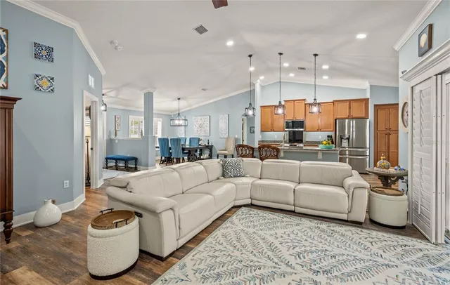a living room with furniture and kitchen view