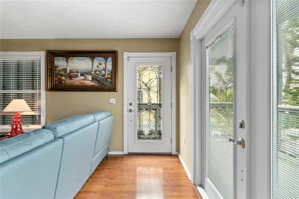 a hallway with a large window and front door