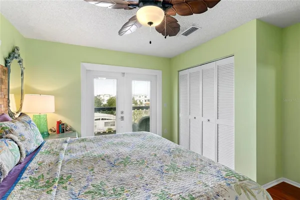 a bedroom with a bed and a chandelier