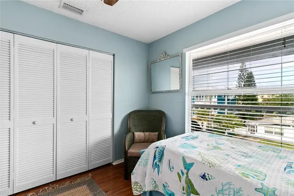 a bedroom with a bed and a chair