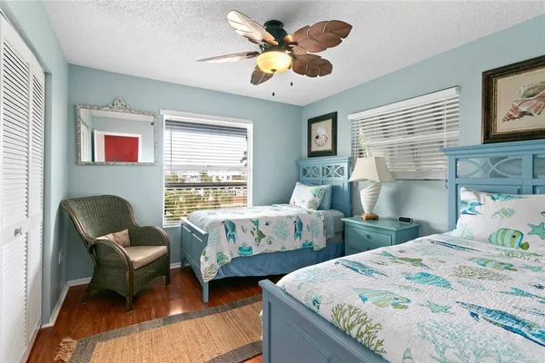 a bedroom with two beds and a large window