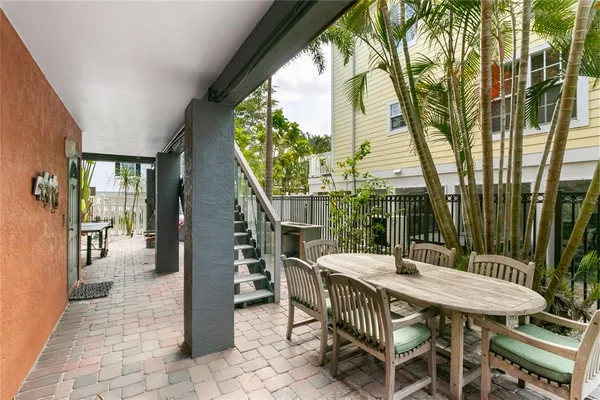 a view of a patio with table and chairs and potted plants