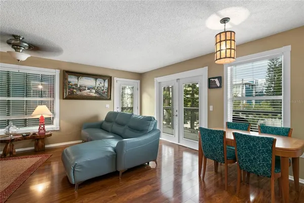 a living room with furniture wooden floor and a window