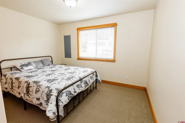 a bed sitting in a bedroom next to a window