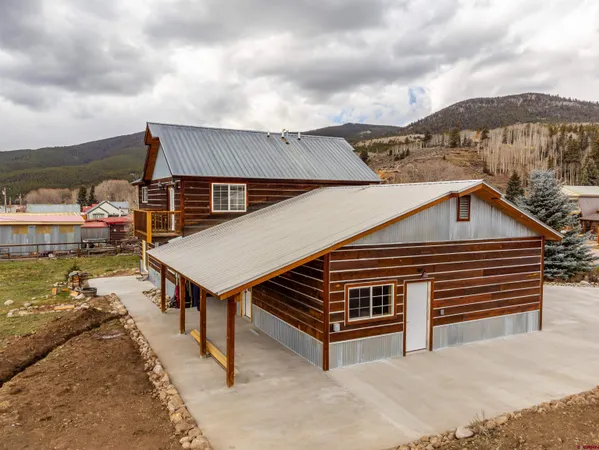 a white bed sitting in a bedroom next to a window