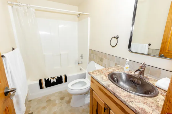 a spacious bathroom with a bathtub and shower