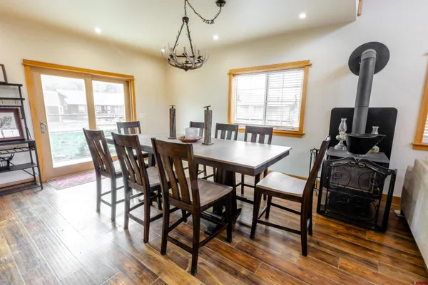 a large kitchen with stainless steel appliances granite countertop a stove a sink dishwasher and a refrigerator with wooden floor