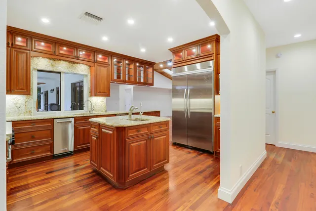 a kitchen with stainless steel appliances granite countertop a stove and a refrigerator