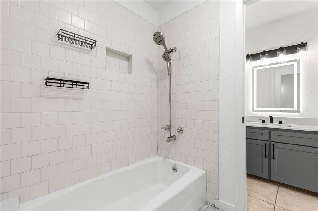 17003 Davenport Road Dallas, TX 75248 - Photo 33 of 40 a bathroom with a bathtub and a sink