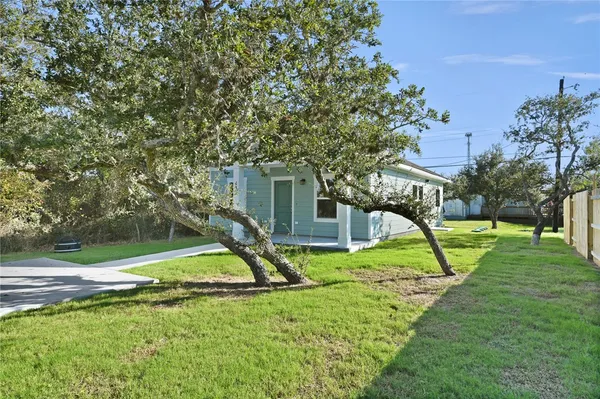 a view of a house with a yard and a slide