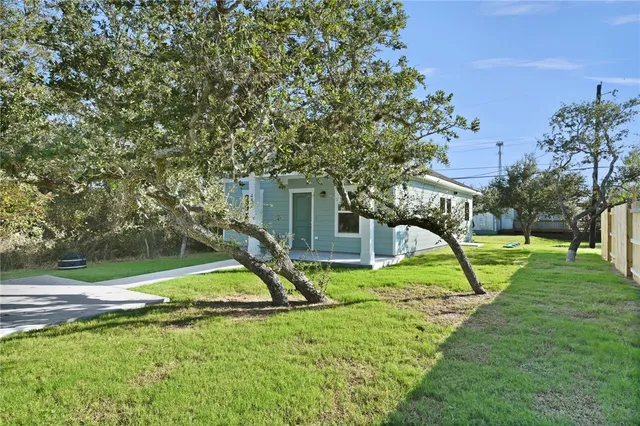 a view of a house with a yard and a slide