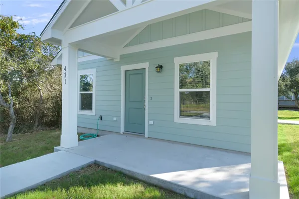 a backyard of a house with yard and outdoor seating