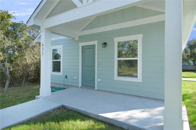 a backyard of a house with yard and outdoor seating