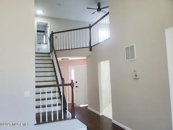 a view of entryway with stairs and wooden floor