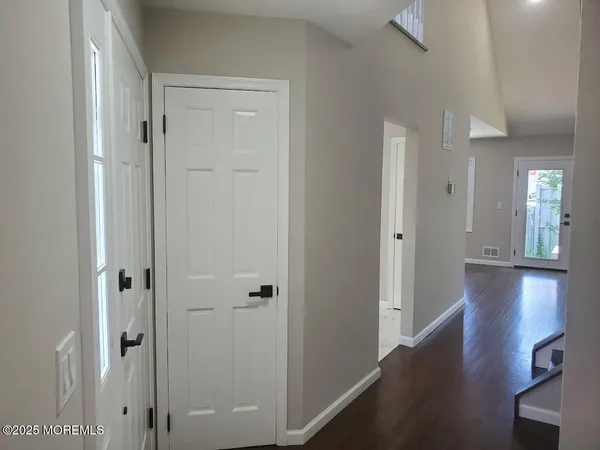 a view of a hallway with wooden floor