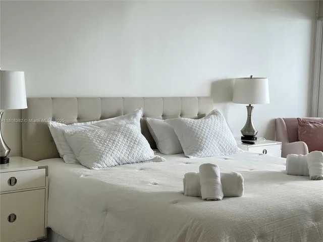 a bedroom with a bed and lamp