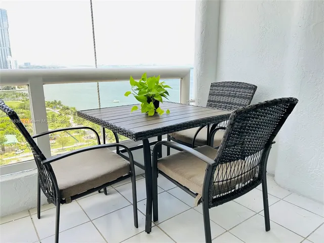 a view of a dining room with furniture and a window