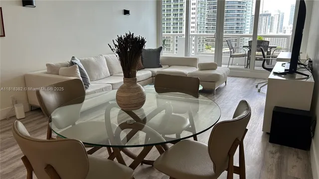a dining room with furniture and wooden floor