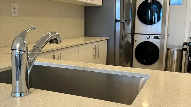 a view of a kitchen with washing machine and a sink
