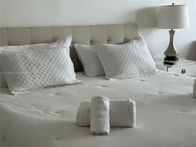 a bedroom with a bed and a lamp