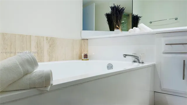 a bathroom with a bathtub and a sink