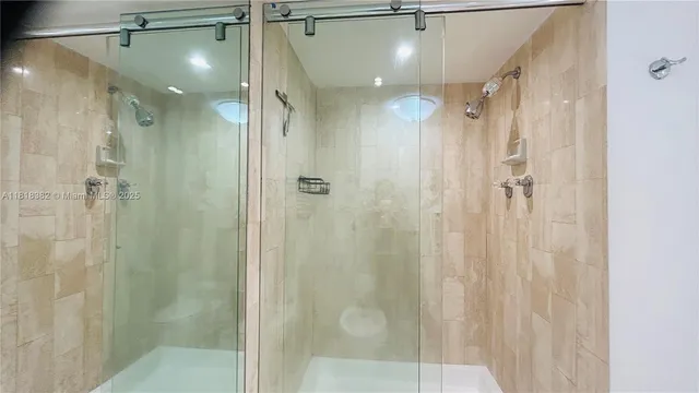 a bathroom with a shower and a glass door
