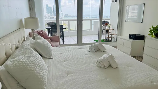 a bed sitting in a bedroom next to a window