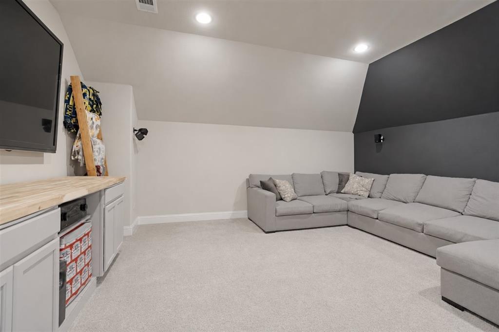 1205 Redbud Street Howe, TX 75459 - Photo 29 of 40 a living room with furniture and a flat screen tv