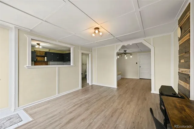 a view of empty room with wooden floor