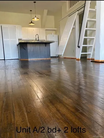 a view of a room with wooden floor